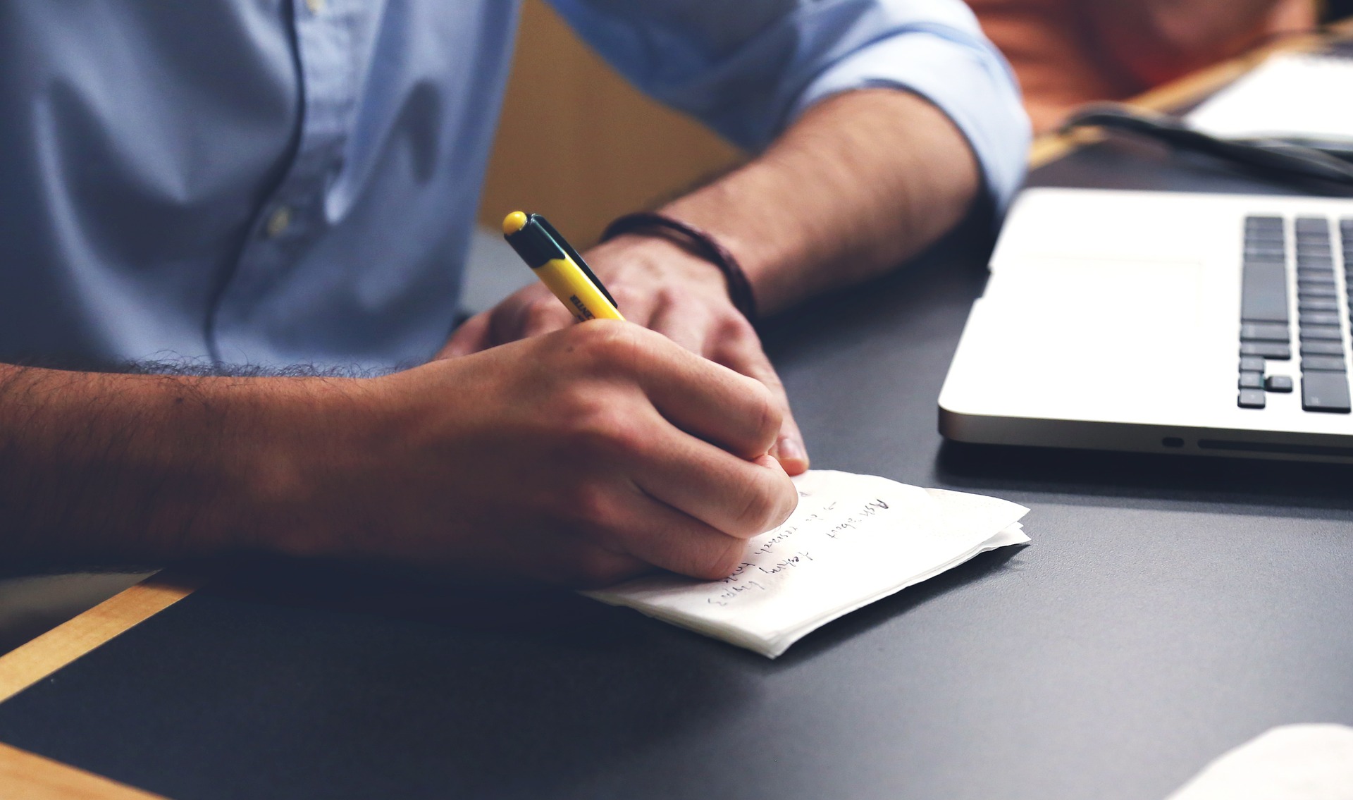 Hand writing notes in a notepad